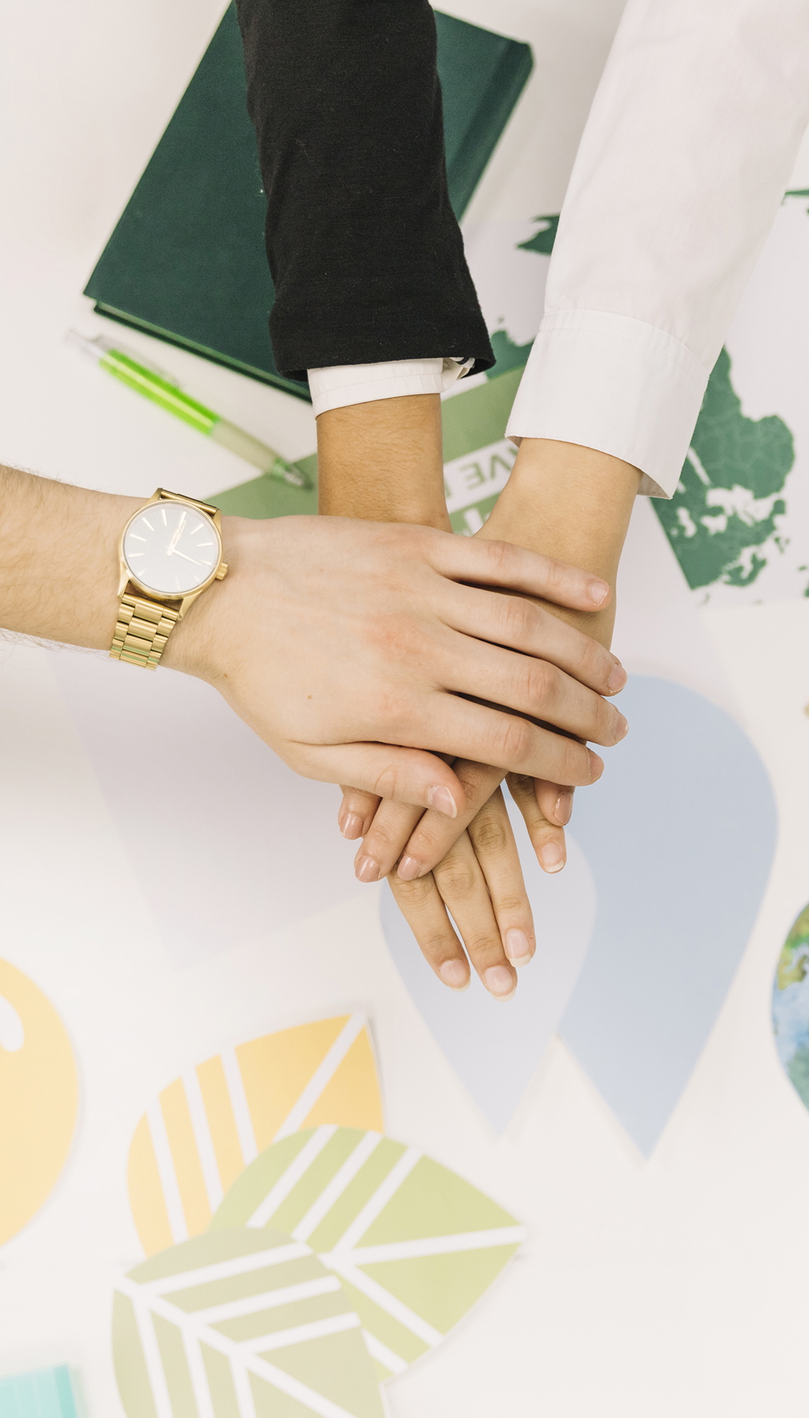group-businesspeople-stacking-their-hands-desk